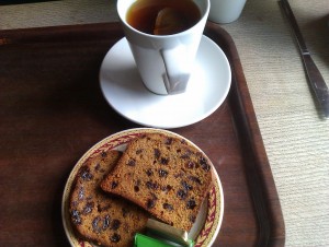 Photo of two slices of fruitcake and a cup of tea